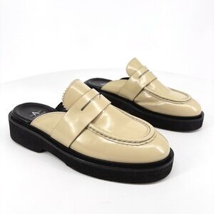 Aquatalia Cream and Black Mules